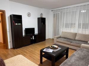 a living room with a couch and a table at Boulevard Mitrovica in Mitrovica