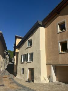 a large brick building with windows on a street at ValTho Orelle Le Paradis Blanc in Orelle