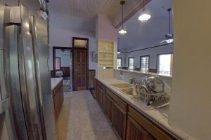 a large kitchen with a sink and a counter at Charming 2BR Beach House Ideal for Extended Stays in Placencia