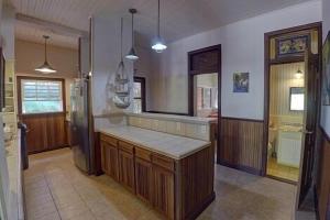 a kitchen with a counter top in a room at Charming 2BR Beach House Ideal for Extended Stays in Placencia