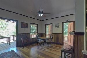 a living room with a dining room table and chairs at Charming 2BR Beach House Ideal for Extended Stays in Placencia +28 photos