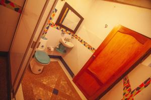 a bathroom with a toilet and a wooden door at Cabaña privada en Oicata in Oicatá +12 photos