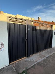 a pair of gates on the side of a building at Casa próximo da Havan, UFMS e ArenaMix com Garagem in Três Lagoas