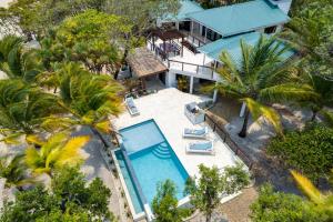 an aerial view of a house with a swimming pool at Picture-Perfect 2-Bedroom Oceanfront Home w Pool in Placencia