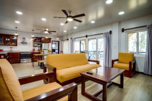 a living room with a couch and a table at Elegant Beachfront Villa Pool & Beach Family Fun in Maya Beach +44 photos