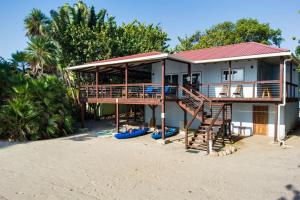 a house on the beach with a deck and stairs at Spacious Beachfront Family Home w Caribbean Views in Maya Beach +43 photos