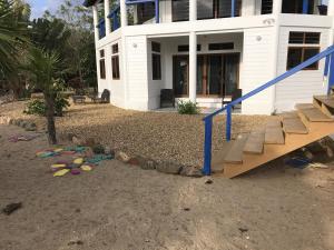 a house with a playground in front of it at Beachfront 3-Bed, 2-Bath Family Getaway with Pool in Placencia