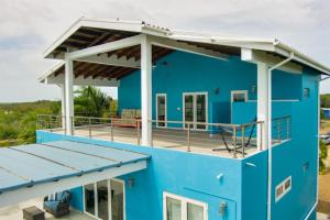 a blue house with a white roof at Grand Sunset Decks Luxury Home on the Lagoon in Maya Beach +65 photos