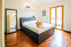 a bedroom with a large bed and a mirror at Villa Lepre in Casarza Ligure