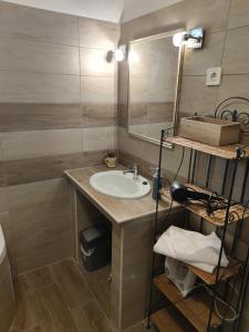 a bathroom with a sink and a mirror at Vazsita ház in Erdőbénye +21 photos