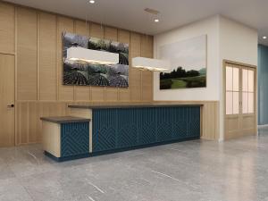 a lobby with a reception desk and paintings on the wall at Hotel Bridgton in Bridgton +7 photos
