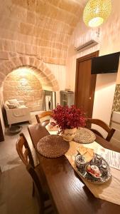 a wooden table with a vase of flowers on it at Luxury Vittoria in Ceglie Messapica +27 photos