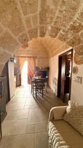 a living room with a couch and a table at Luxury Vittoria in Ceglie Messapica
