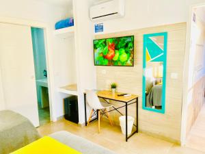 a room with a desk and a table in a room at DORI ROOMS - Hostal in Tarifa