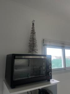 a television and a christmas tree in a room at Refugios del Parque in Necochea