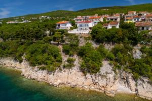 a group of houses on a cliff next to the water at Villa Empress in Dramalj