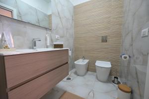 a bathroom with a sink and a toilet at Arabia Suites in Cosenza