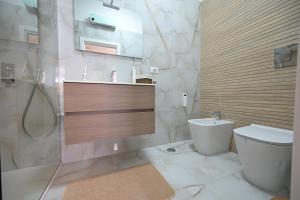 a bathroom with a toilet and a sink and a shower at Arabia Suites in Cosenza