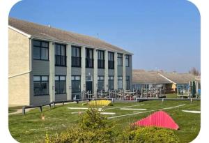 a large building with a playground in front of it at The cosy house in Corton