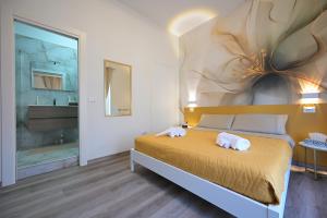 a bedroom with a bed with two towels on it at Arabia Suites in Cosenza