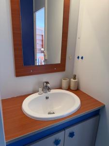 a bathroom with a white sink and a mirror at Horizon Marin Escapade bord de mer à Cancale in Cancale +10 photos