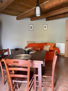 a dining room with a table and a couch at Noce Melano in Montattico +6 photos