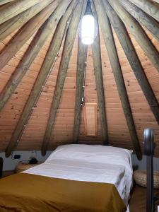 a bedroom in a wooden cabin with a bed at Noce Melano in Montattico