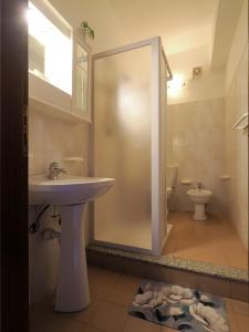 a bathroom with a sink and a toilet at Camere Santa Margherita in Santa Margherita-Sant'Alessio Siculo