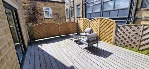 a wooden deck with a bench on a building at SELF CHECK in APARTMENT IN CENTRAL HALIFAX in Halifax