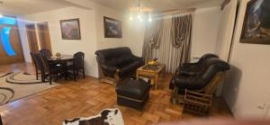 a living room with two leather chairs and a table at Vila Bucan in Rožaje