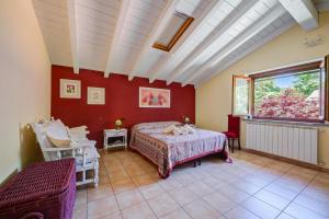 a bedroom with a bed and a large window at Villa La Dolce Vita: Lake Maggiore 3BR, Fenced Garden, Parking near Beaches - Happy Rentals in Leggiuno