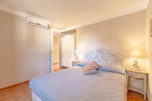 a bedroom with a large bed with two pillows on it at Il Conventaccio Luxury Resort in Ficulle
