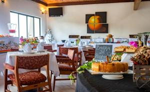 a restaurant with tables and chairs with a cake on a table at Hotel Misión San Miguel de Allende in San Miguel de Allende