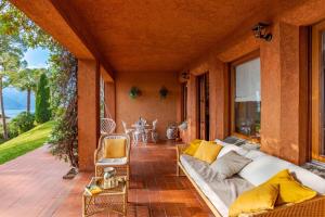a living room with a couch on a patio at Brentano Giardino in Mezzegra