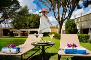 a table with a plate of food and a windmill at Hotel Misión San Miguel de Allende in San Miguel de Allende +10 photos