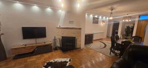 a living room with a fireplace and a flat screen tv at Vila Bucan in Rožaje