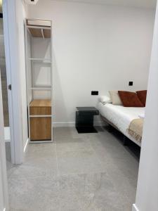 a room with a bed and a walk in closet at La Encina Suites in Salamanca