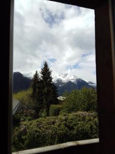 a view of a snow covered mountain from a window at Hotel les Touristes in Verbier