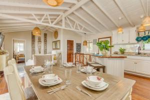 a dining room and kitchen with a table and chairs at Luxury Waterfront 3bd Villa w Pool Dock in Maya Beach +64 photos