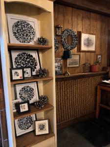 a room with a shelf with pictures on it at The Ship Inn in St Austell
