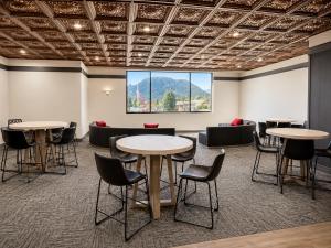 a room with tables and chairs and a large window at Expedition Lodge Estes Park at Rocky Mtn National Park in Estes Park