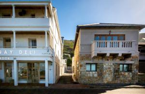 a building with a sign that reads may delilli at Millwood Apartment in Cape Town