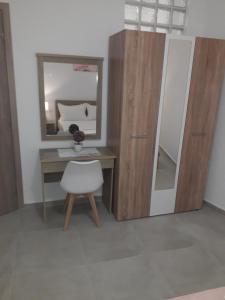 a room with a desk and a mirror and a chair at VILLA stamatia - lena in Limenaria +21 photos
