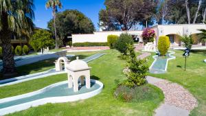 a park with a building in the background with trees at Hotel Misión San Miguel de Allende in San Miguel de Allende
