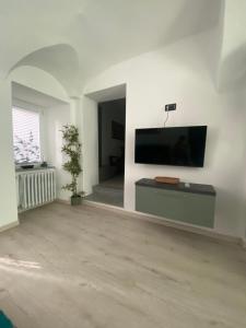 a living room with a flat screen tv on a wall at Casa Piazzetta in Saluzzo