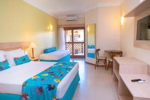 a hotel room with two beds and a table at Portobello Praia in Porto Seguro +100 photos