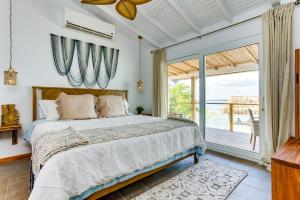 a bedroom with a bed and a large window at Luxurious Lagoon Home w Elegant Decor & Pool in Maya Beach