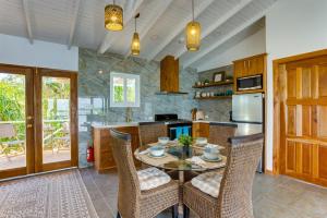 a kitchen with a table with chairs and a refrigerator at Luxurious Lagoon Home w Elegant Decor & Pool in Maya Beach +53 photos