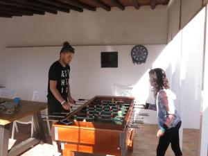 a man and a young girl playing with a foos ball at Luxury Casa da Fonte - Private Heated Salt Pool in Faro