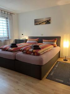 a bedroom with a large bed with pillows on it at Ferienwohnung Zum Rottweiler Städtle - Erdgeschosswohnung in Rottweil